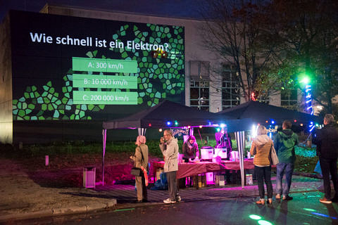 Towards entry "CENEM Titan Building Illuminated in the Green Color of Electrons for the Long Night of Science 2019"